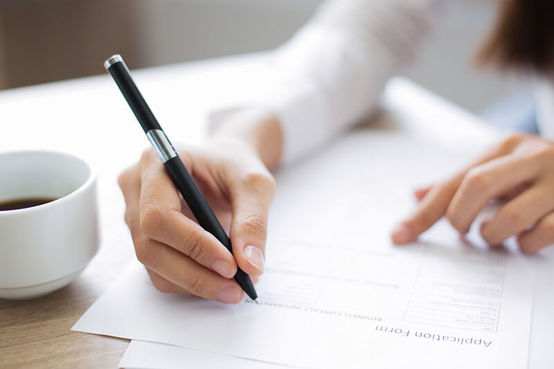 Closeup of a Woman Filling Out a Form