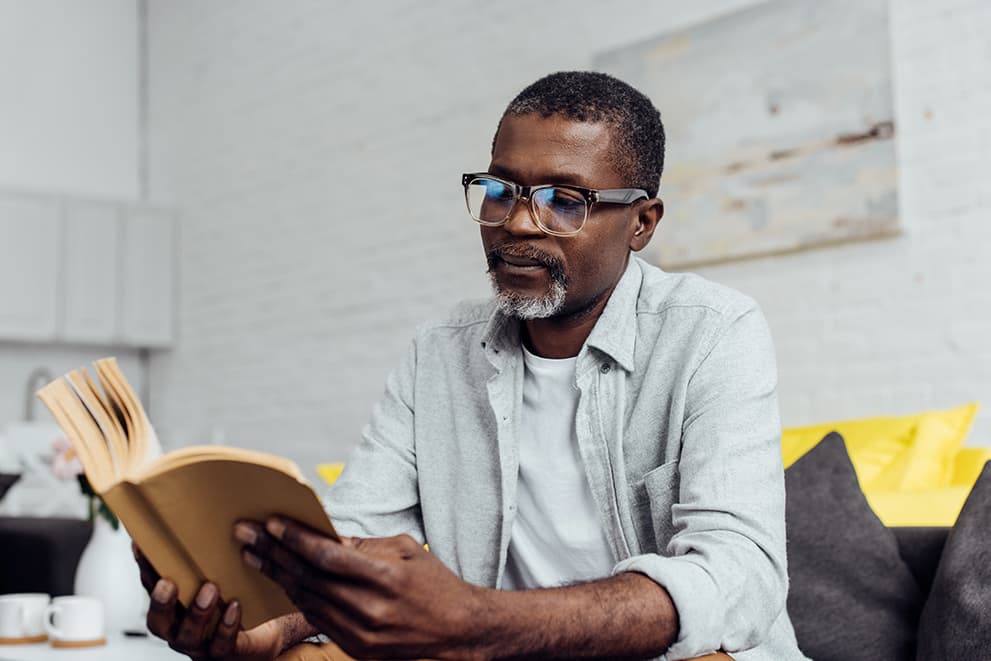 Older African American man reading book