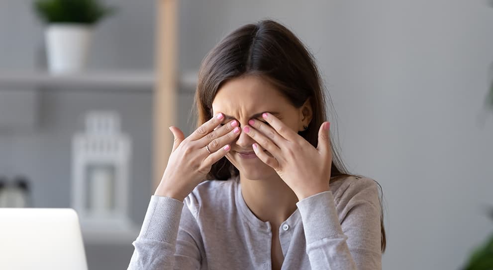 Woman rubbing eyes